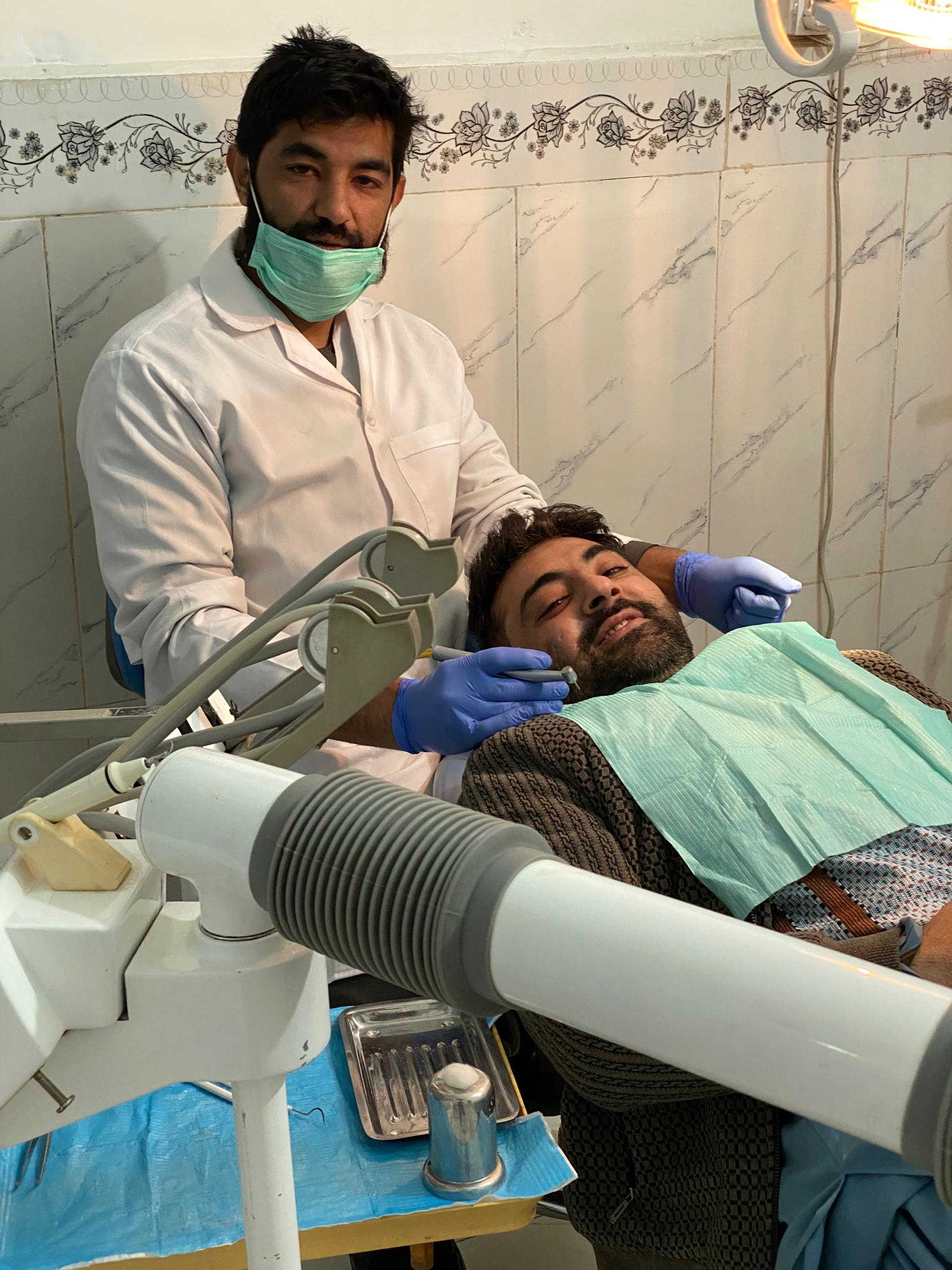 Dr. Temorshah Hisham treating a patient